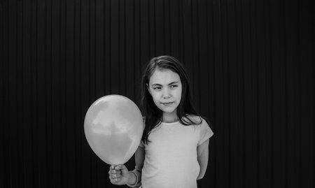 girl holding a balloon black and white photo.の写真素材
