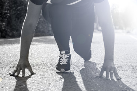girl about to start running and racing outdoors.の写真素材