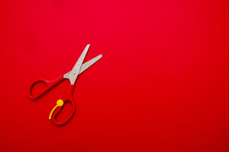 children's scissors on the red background with copy space.の写真素材
