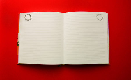 open blank notepad on red background with copy space.