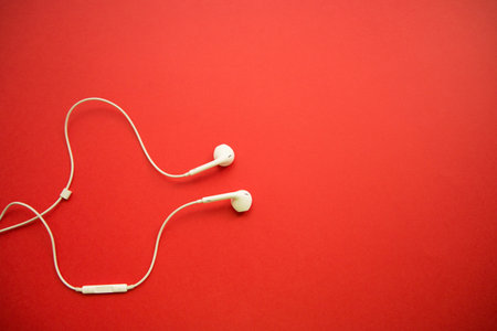 white headphones on red background with copy space.の写真素材