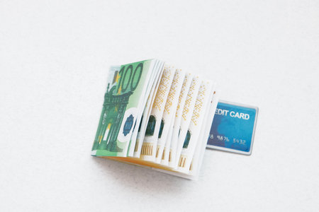 Euro money stack and credit card on white background.の写真素材