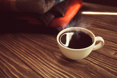 a hot Cup of coffee on a background of wool, a vintage image selective focus.の写真素材
