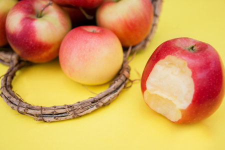 apple in basket on yellow background composition and concept of autumn.の写真素材