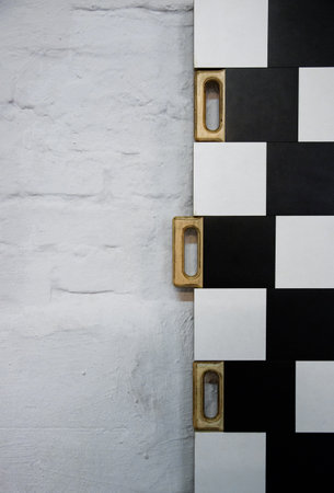 half black and white random checkered texture wooden handles to move the boards to the sides of the background.の写真素材