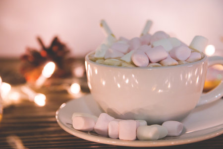 hot chocolate with marshmallow candy and Christmas decorations on a wooden background.の写真素材
