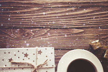 coffee Cup gift boxes snowflakes on wooden background, Christmas background.の写真素材
