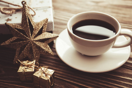 coffee Cup gift boxes snowflakes on wooden background, Christmas backgroundの写真素材