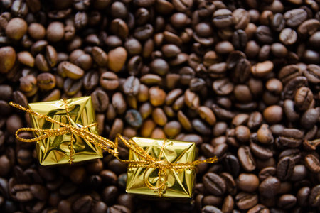 Christmas gifts on coffee beans background, selective focus.の写真素材