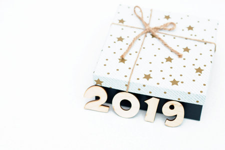 gift box and symbol numbers 2019 new year on white background, simple flatlay card of new year.