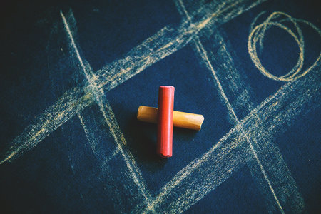 cross zero of colored crayons and toe painted on dark background.の写真素材