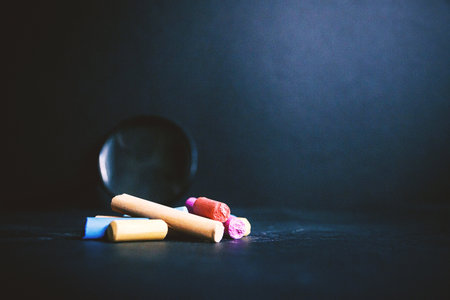 Pastel pencils pieces on a dark background random color closeup on dark background.の写真素材