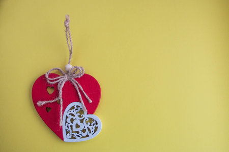 handmade red heart close-up on yellow background, symbol of love, happy Valentine's day.の写真素材