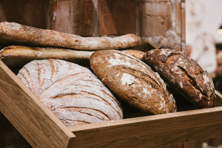 different fresh bread on the shelves in bakery. Selective focus.