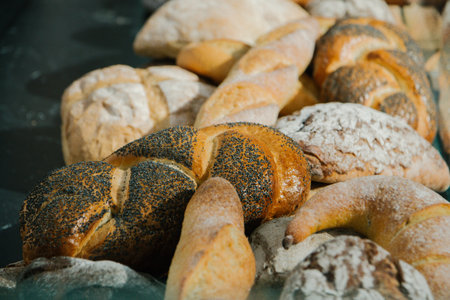 different fresh bread on the shelves in bakeryの写真素材