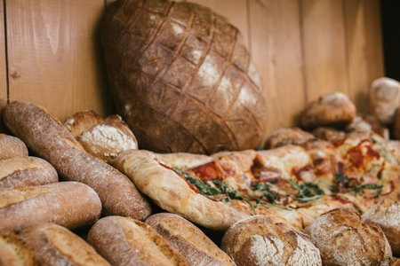 different fresh bread on the shelves in bakery. Selective focus.の写真素材