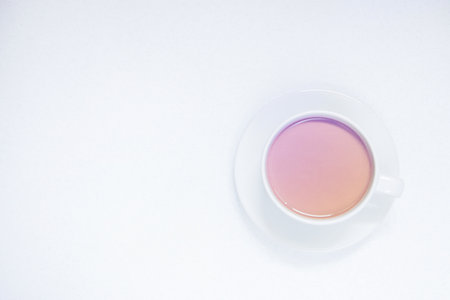 Cup of coffee with milk on a white background, top view, toned.の写真素材