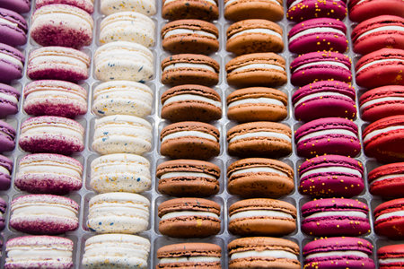 Bright beautiful macaroons with tender and flavorful cream. The contrast of colors and the ideal form, selective focus.の写真素材