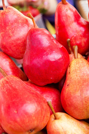 red ripe juicy pears neatly laid out on the market showcase.