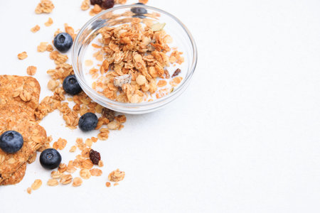 Crunchy muesli and blueberry Breakfast cereals isolated on white background, selective focus, top...