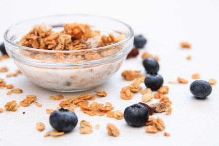 Crunchy muesli and blueberry Breakfast cereals isolated on white background, selective focus, top...