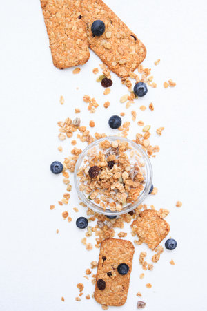 Crunchy muesli cookies and blueberries, Breakfast cereals isolated on white background, selective focus, top view.の写真素材