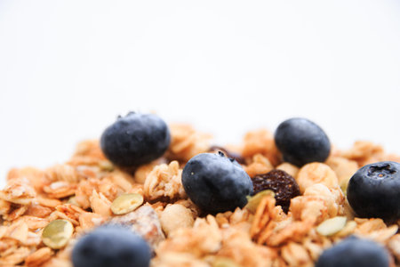 Crunchy muesli and blueberry Breakfast cereals isolated on white background, selective focus, top...