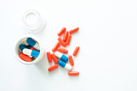 Multicolored white bottle capsules on white isolated background, copyspace for text, selective...