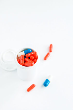 Multicolored white bottle capsules on white isolated background, copyspace for text, selective...