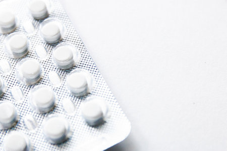 tablets in blisters isolated on white background, copyspace for text, selective focus, top view. Pain drugs, health, pills for the treatment of the concept of addiction.の写真素材
