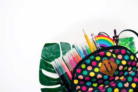 Bright colored backpack and colorful stationary school supplies on white background, space or text flat layer. Concept back to school. Close-up, copy space, flat lay.の写真素材