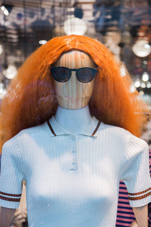 mannequins with modern clothes in fashion store display window.の写真素材