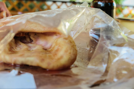 Smoked pork ear on on wooden background in package, offal.の写真素材