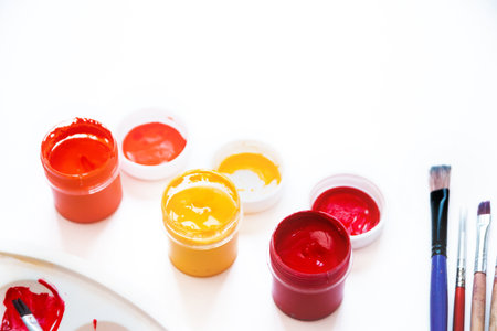 Bright autumn colors, acrylic paints, brushes and palette on white background, space or flat text layer. Concept back to school. Close-up, copy space, flat lay.の写真素材