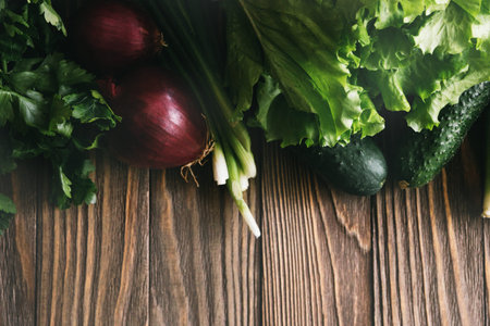 Fresh organic food, fresh vegetables. Lettuce, cucumber, celery, onion, avocado and parsley on...