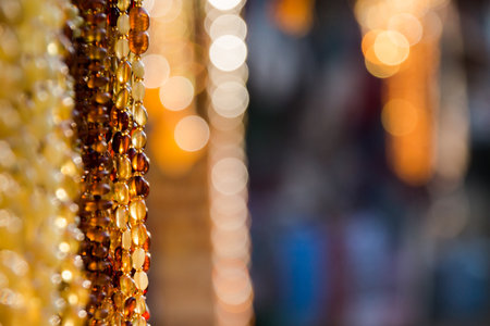 Amber background of beads and necklaces at the handicraft market. Jewelry design.の写真素材