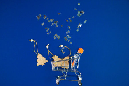 New year and Christmas concept flatlay holiday decorations on blue background with copy space.