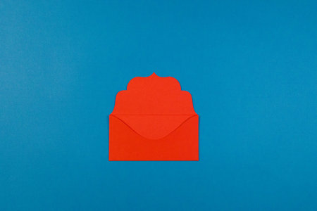Communication, newsletter and business concept- red colorful envelope on blue background, selective...