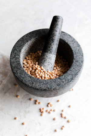 peas with a ceramic mortar for grinding close-up on a white background, selective focus.の写真素材