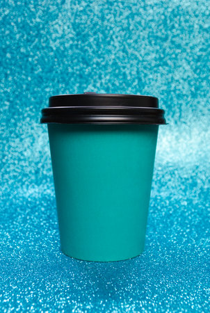 Good morning wake up awake concept. Simply flatlay design blue paper coffee cup isolated on blue shiny colorful trendy background.の写真素材