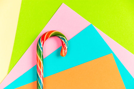 Flatlay of lollipop on multicolored paper background. Selective focus.の写真素材