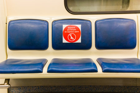 An empty wagon of the Moscow metro, the seats are marked with stickers for compliance distance during Covid-19 epidemic. Moscow, Russia, May 2020.のeditorial素材