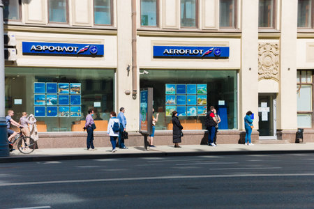 Unknown people are waiting in line for payments, or registration of tickets for departure from the...