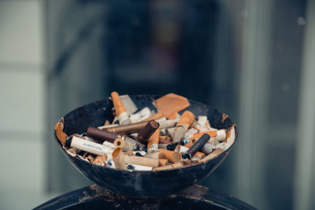 Street ashtray, the box is full of different cigarette butts, ecology. Moscow, Russia, June 2020.のeditorial素材