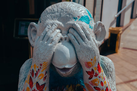 Street photo of a figure of a bright multicolored monkey with closed eyes of unusual color depicts various emotions. Moscow. Russia. June 2020.のeditorial素材