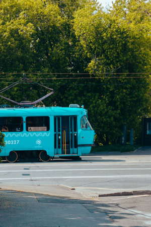 Public transport blue tram with opening doors with passengers inside. Moscow, Russia, June 2020.