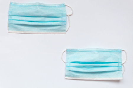 two blue masks on a white table