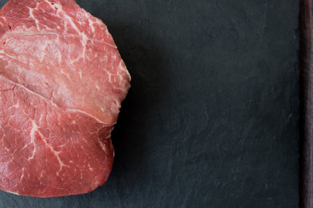 meat on a black board made of stoneの写真素材