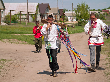 Young men in national dresses on a traditional Russian holiday