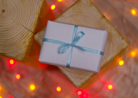 Christmas gift or New Year with  ribbon on vintage wood  on night  bokeh backgroundの写真素材